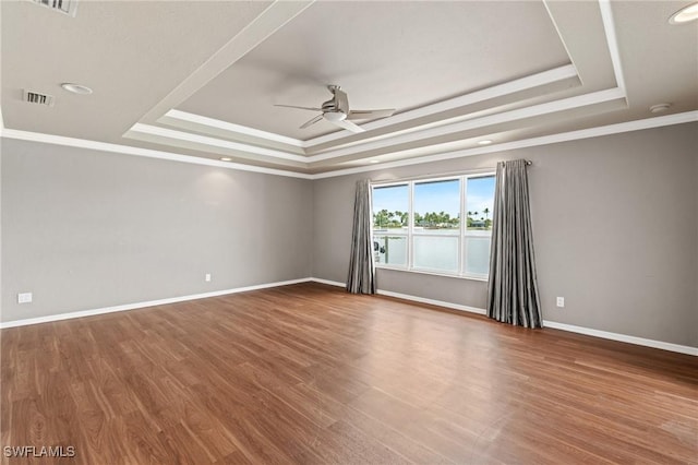 1703 SW 6th Ave, Cape Coral, FL 33991 - spare room with a raised ceiling, ceiling fan, wood finished floors, baseboards, and crown molding