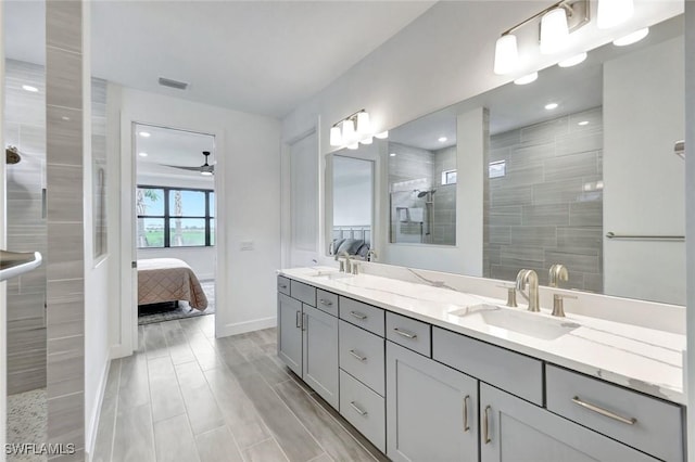 ensuite bathroom with a sink, ensuite bath, walk in shower, and visible vents