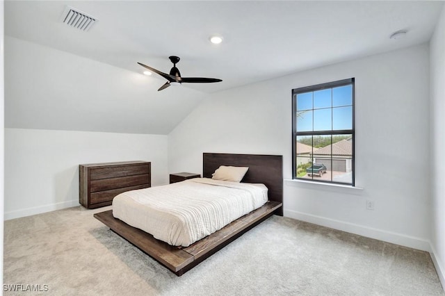 bedroom with baseboards, lofted ceiling, visible vents, and carpet