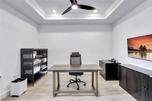 office featuring a raised ceiling, ornamental molding, and ceiling fan