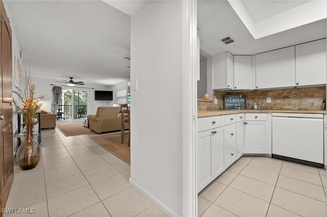 kitchen featuring decorative backsplash, ceiling fan, dishwasher, light tile patterned floors, and white cabinets