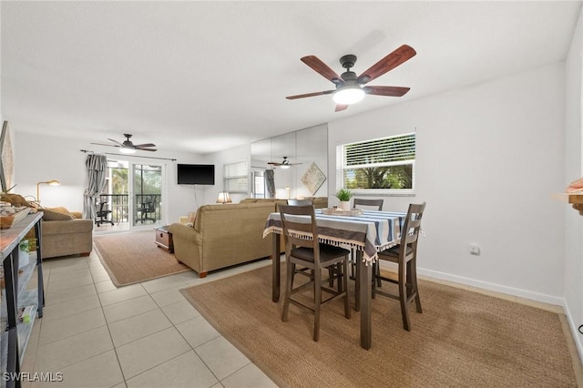 dining room featuring baseboards, ceiling fan, and light tile patterned flooring