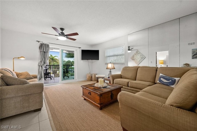 living area featuring a ceiling fan, visible vents, and a wealth of natural light