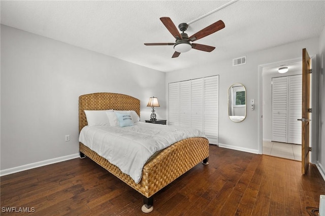 bedroom with baseboards, visible vents, ceiling fan, and hardwood / wood-style flooring