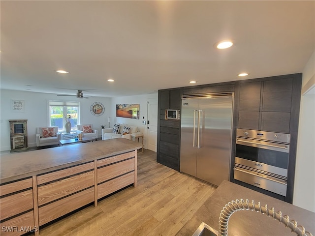 160 Coral Vine Dr, Naples, FL 34110 - kitchen featuring light wood-style flooring, a warming drawer, appliances with stainless steel finishes, and recessed lighting