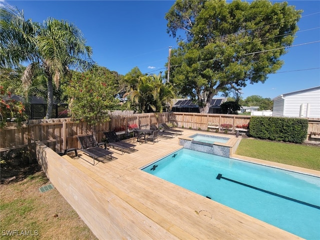 160 Coral Vine Dr, Naples, FL 34110 - view of pool featuring a lawn, a wooden deck, a pool with connected hot tub, and a fenced backyard