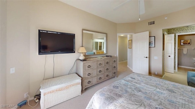 bedroom featuring light carpet and baseboards