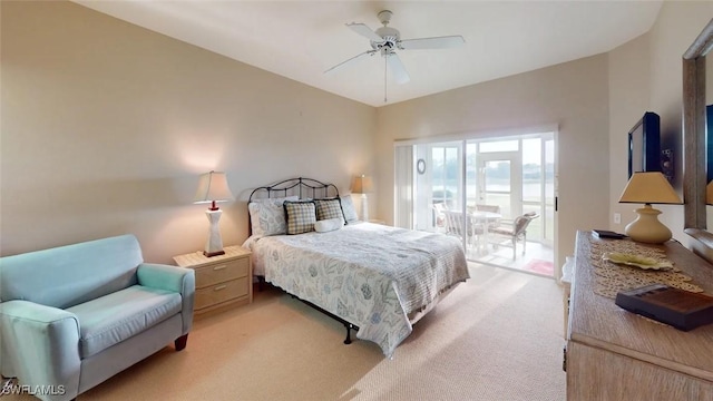 bedroom featuring light colored carpet, access to outside, and a ceiling fan