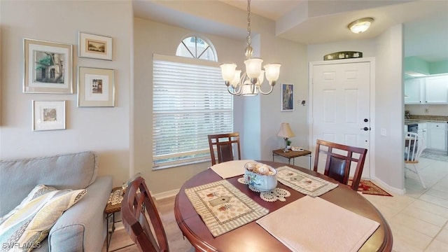 dining room featuring a chandelier, baseboards, and light tile patterned floors