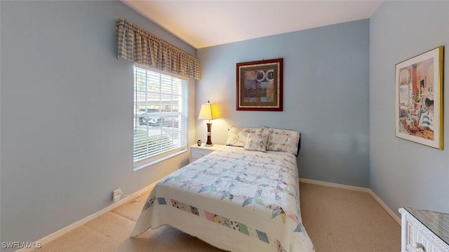 bedroom with carpet flooring and baseboards