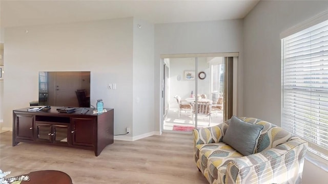 living area with light wood finished floors and baseboards