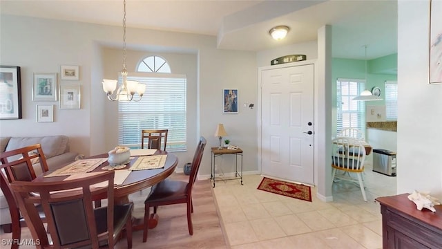 dining space with a chandelier and baseboards