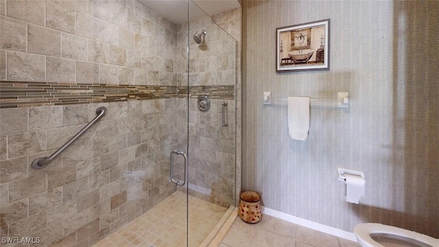 full bathroom featuring a shower stall, toilet, tile patterned flooring, and baseboards