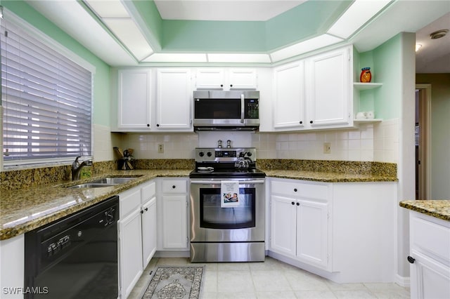 kitchen featuring appliances with stainless steel finishes, a sink, open shelves, and white cabinets