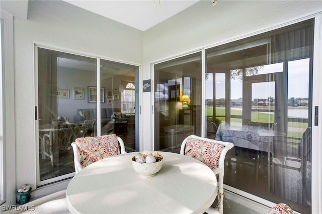 sunroom / solarium featuring outdoor dining space