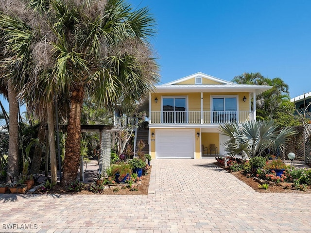 4738 Jackfish St, Bonita Springs, FL 34134 - coastal home featuring an attached garage and decorative driveway