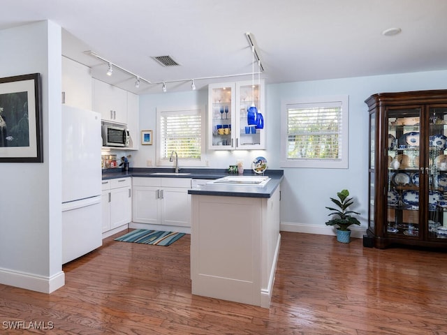 4738 Jackfish St, Bonita Springs, FL 34134 - kitchen with stainless steel microwave, baseboards, freestanding refrigerator, dark countertops, and a sink