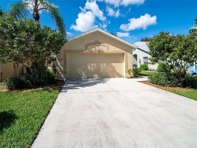 view of front of home with a garage, driveway, and stucco siding