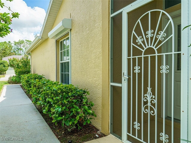 property entrance with stucco siding