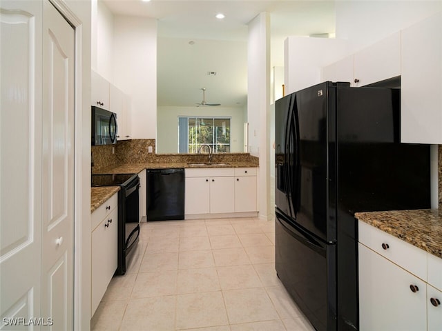 kitchen with white cabinets, a sink, light tile patterned flooring, backsplash, and black appliances