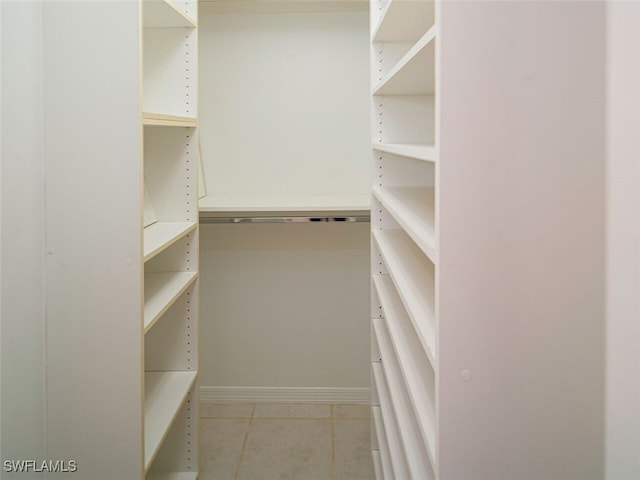 spacious closet featuring light tile patterned floors