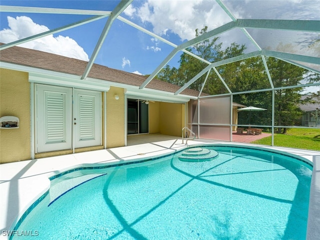 outdoor pool featuring a lanai and a patio area