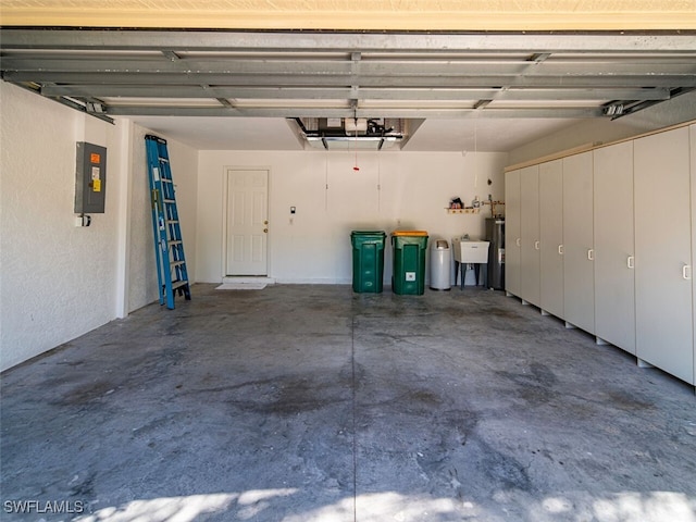 garage featuring electric panel, water heater, and a sink