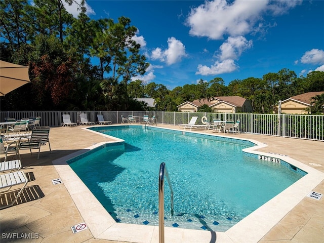 pool with fence and a patio area