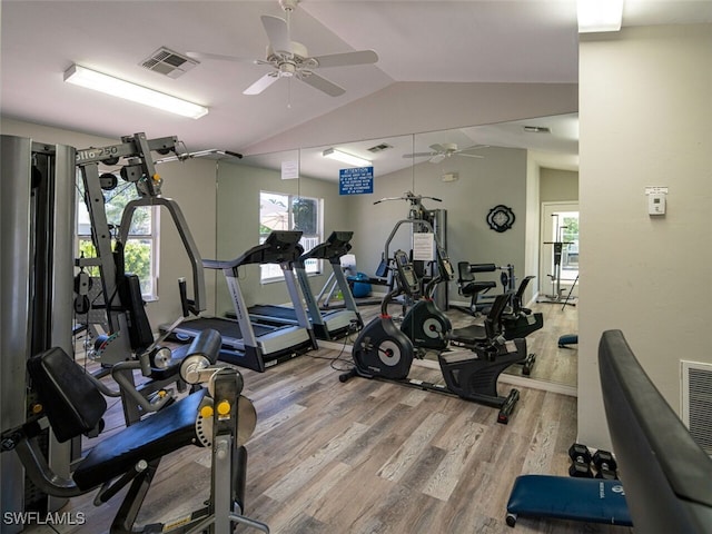 workout area with vaulted ceiling, wood finished floors, visible vents, and ceiling fan