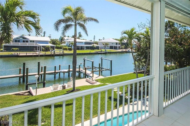 dock area with a lawn, a water view, and a residential view