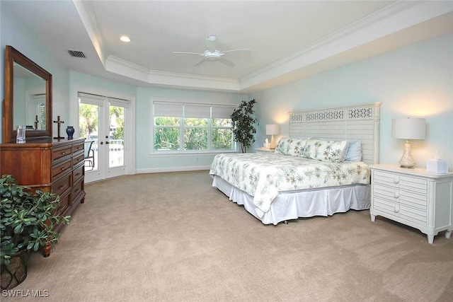 bedroom with access to exterior, a raised ceiling, light colored carpet, visible vents, and ornamental molding