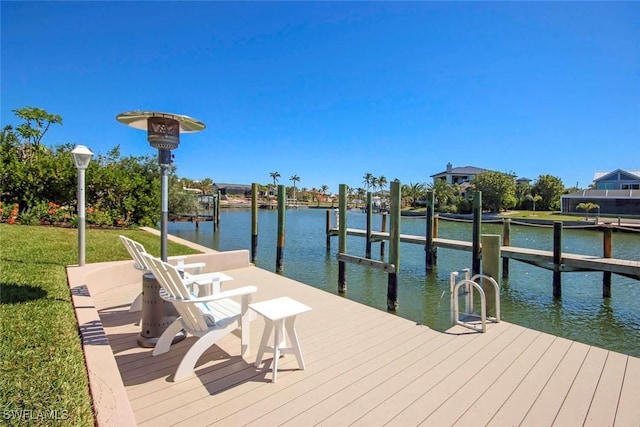 view of dock with a water view and a yard