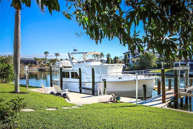 dock area with a lawn, a water view, and boat lift
