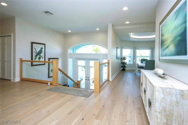 foyer entrance featuring visible vents, baseboards, light wood finished floors, and recessed lighting