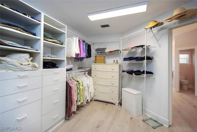 spacious closet featuring visible vents and light wood-style flooring