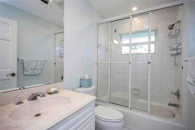 bathroom with enclosed tub / shower combo, toilet, and vanity