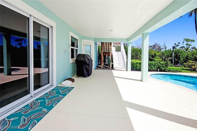 view of patio / terrace featuring stairway, area for grilling, and an outdoor pool