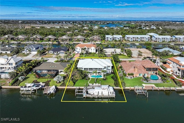 drone / aerial view featuring a residential view and a water view