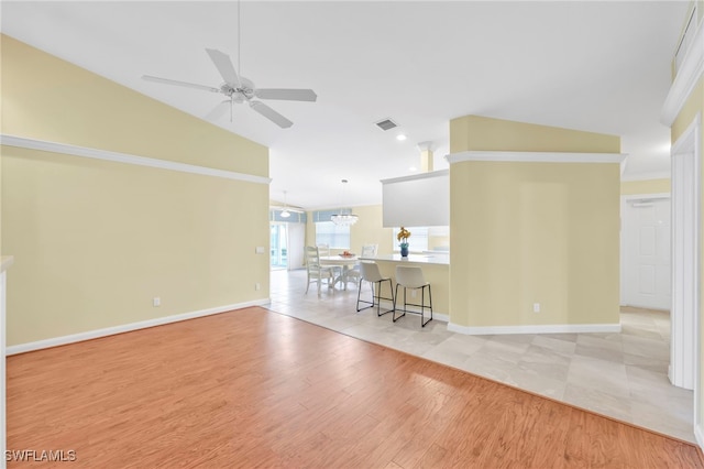 7547 Novara Ct, Naples, FL 34114 - living room featuring light wood finished floors, a ceiling fan, visible vents, baseboards, and lofted ceiling