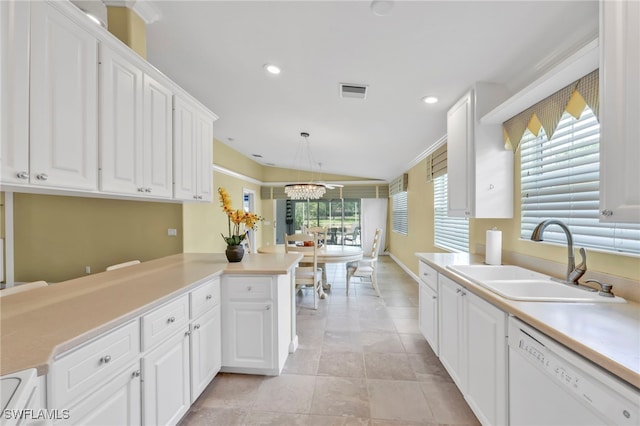 7547 Novara Ct, Naples, FL 34114 - kitchen with white dishwasher, a sink, vaulted ceiling, light countertops, and white cabinets