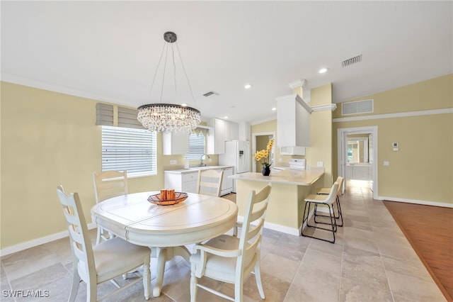 7547 Novara Ct, Naples, FL 34114 - dining area featuring a notable chandelier, baseboards, and visible vents
