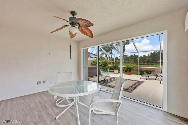 7547 Novara Ct, Naples, FL 34114 - dining space with ceiling fan, a sunroom, and wood finished floors