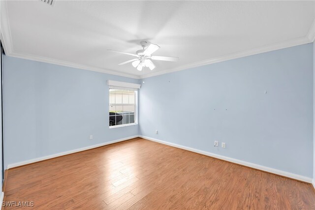 7547 Novara Ct, Naples, FL 34114 - empty room featuring ceiling fan, crown molding, baseboards, and wood finished floors