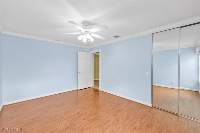 7547 Novara Ct, Naples, FL 34114 - unfurnished bedroom featuring baseboards, visible vents, crown molding, and wood finished floors