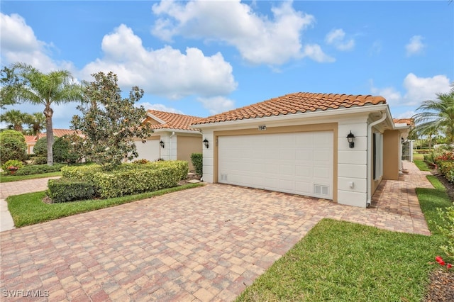 7547 Novara Ct, Naples, FL 34114 - mediterranean / spanish house featuring stucco siding, a tiled roof, a garage, and decorative driveway