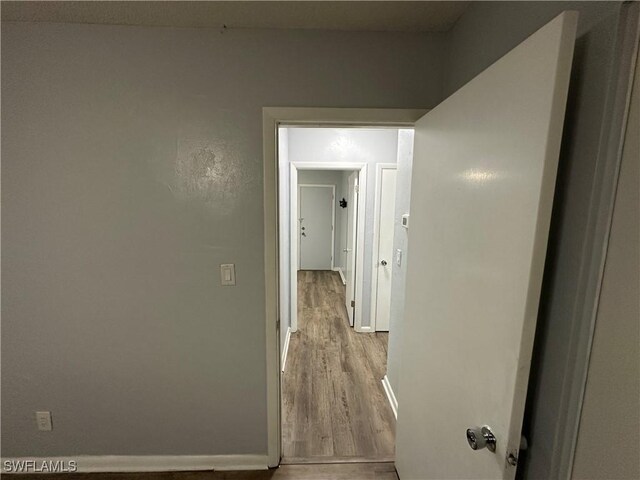 1376 Archer St Unit 6, Lehigh Acres, FL 33936 - hallway with baseboards and wood finished floors