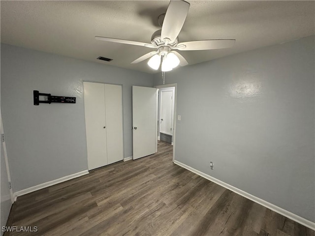 1376 Archer St Unit 6, Lehigh Acres, FL 33936 - unfurnished bedroom featuring baseboards, dark wood-style floors, visible vents, and ceiling fan