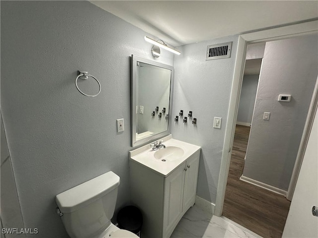 1376 Archer St Unit 6, Lehigh Acres, FL 33936 - bathroom featuring vanity, toilet, baseboards, marble finish floor, and visible vents