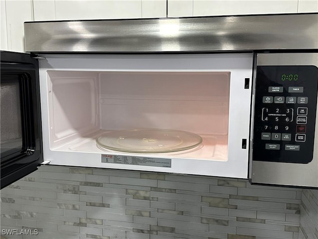1376 Archer St Unit 6, Lehigh Acres, FL 33936 - room details featuring white cabinetry and stainless steel microwave