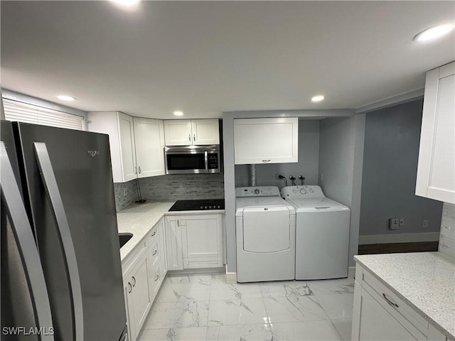 1376 Archer St Unit 6, Lehigh Acres, FL 33936 - washroom featuring washing machine and clothes dryer, marble finish floor, recessed lighting, and cabinet space